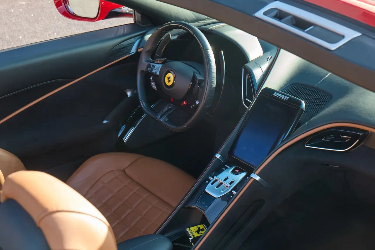 Ferrari Roma Spider 2024, rear view — Courchevel Luxury Car Rental, Courchevel. The Ferrari Roma Spider carries its 620 hp with the manners of a grand tourer rather than…