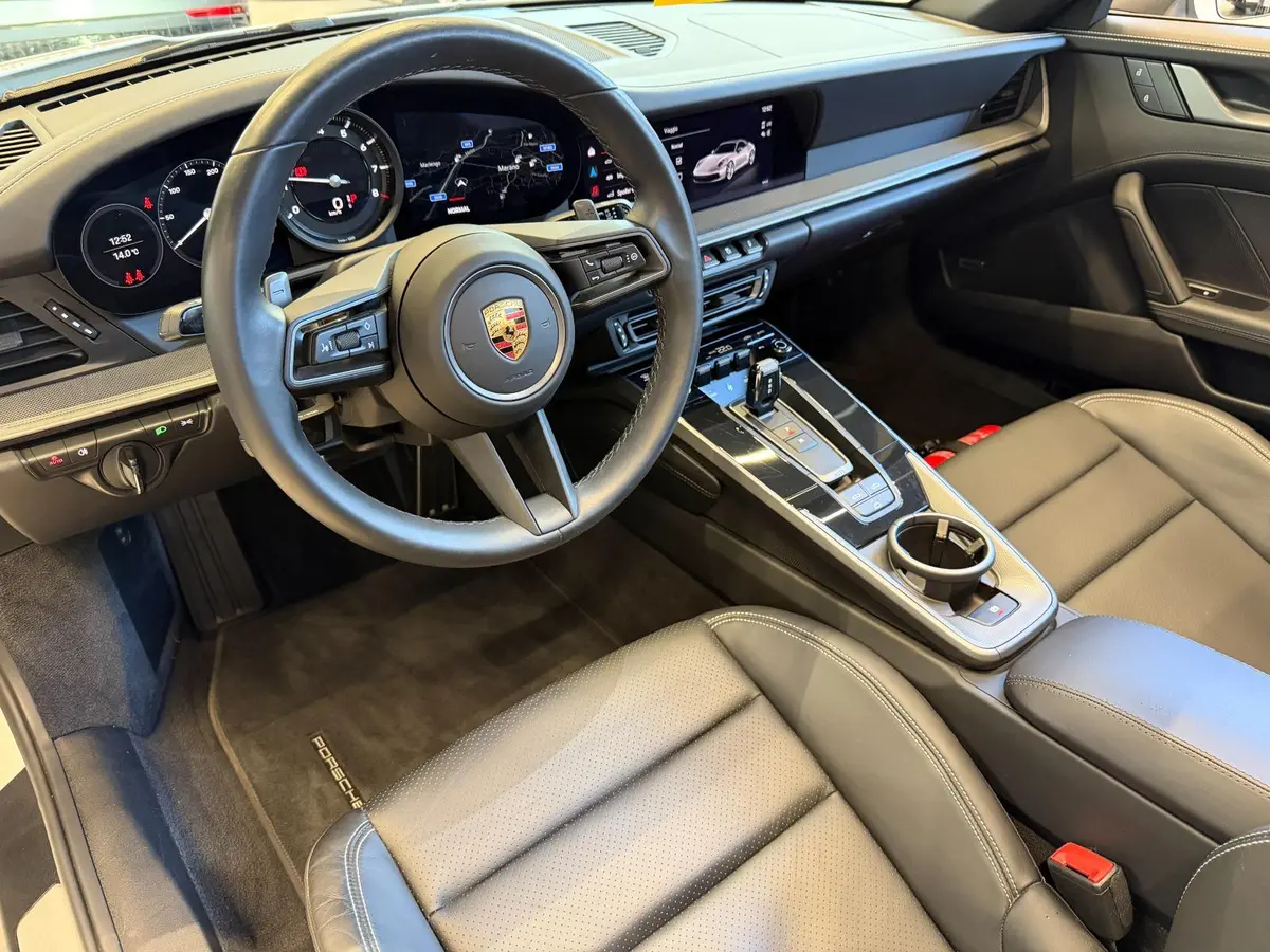 Porsche 911 Carrera S Cabrio (992) 2025, front view — Courchevel Luxury Car Rental, Courchevel. The 2025 Porsche 911 Carrera S Cabrio (992) pairs 480 hp with the kind of steering…