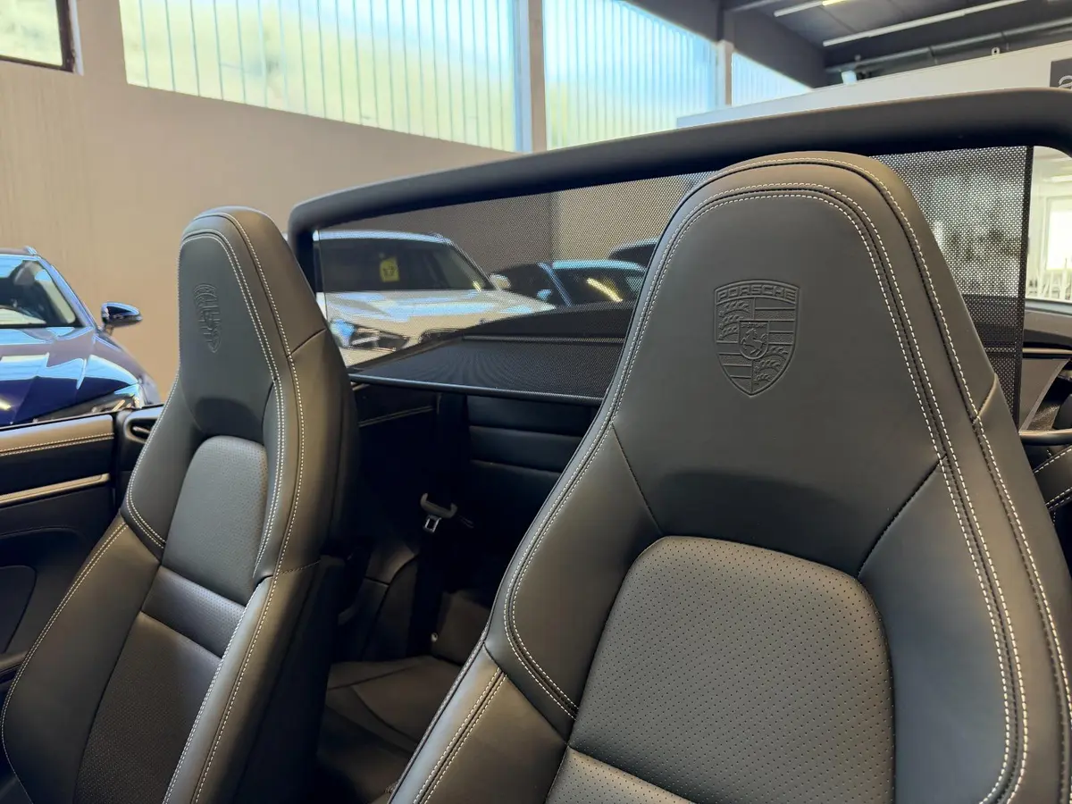 Porsche 911 Carrera S Cabrio (992) 2025, rear view — Courchevel Luxury Car Rental, Courchevel. The 2025 Porsche 911 Carrera S Cabrio (992) pairs 480 hp with the kind of steering…